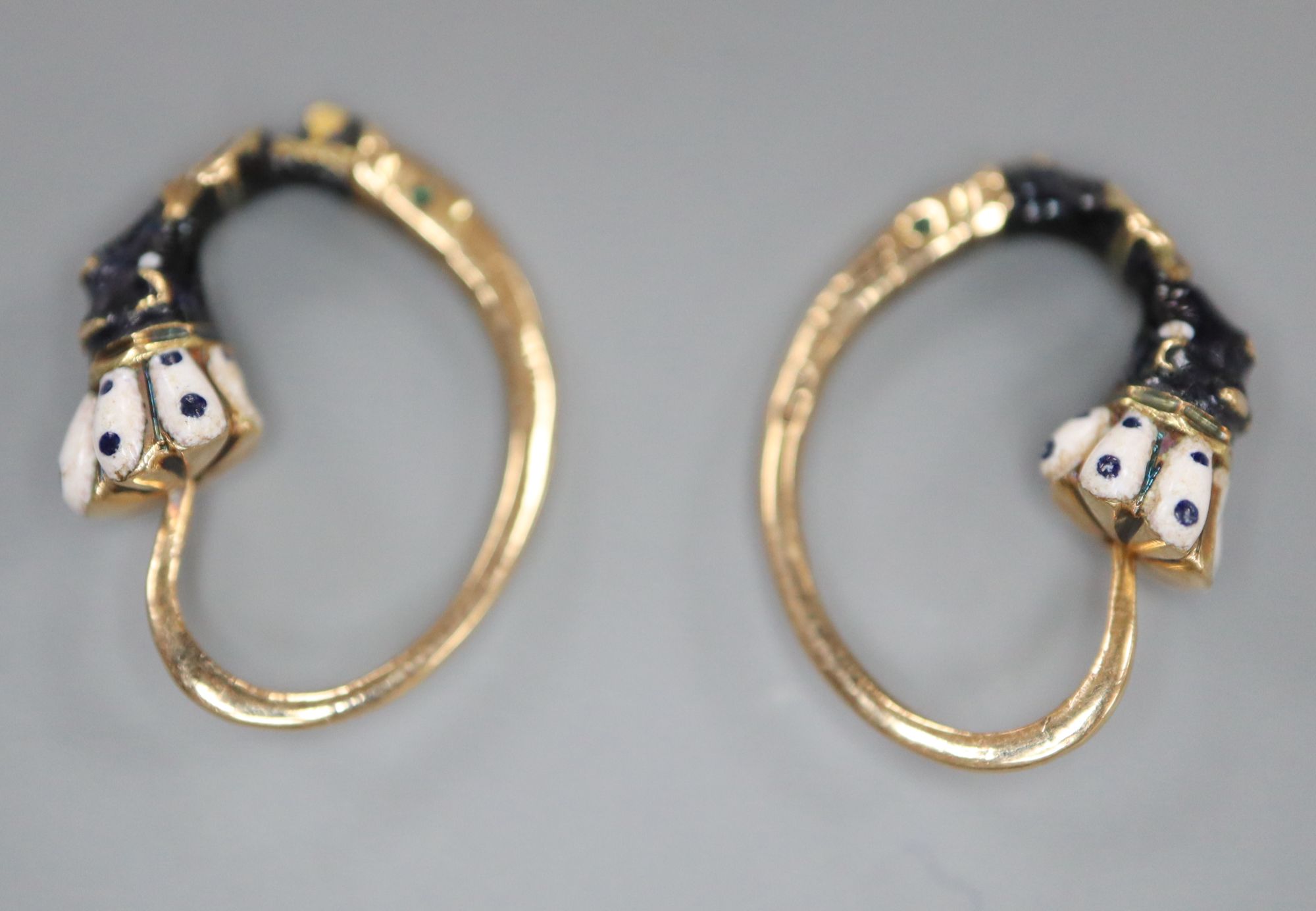 A pair of early 20th century Austro-Hungarian yellow metal and enamelled Blackamoor loop earrings, 15mm, gross 2.1 grams.